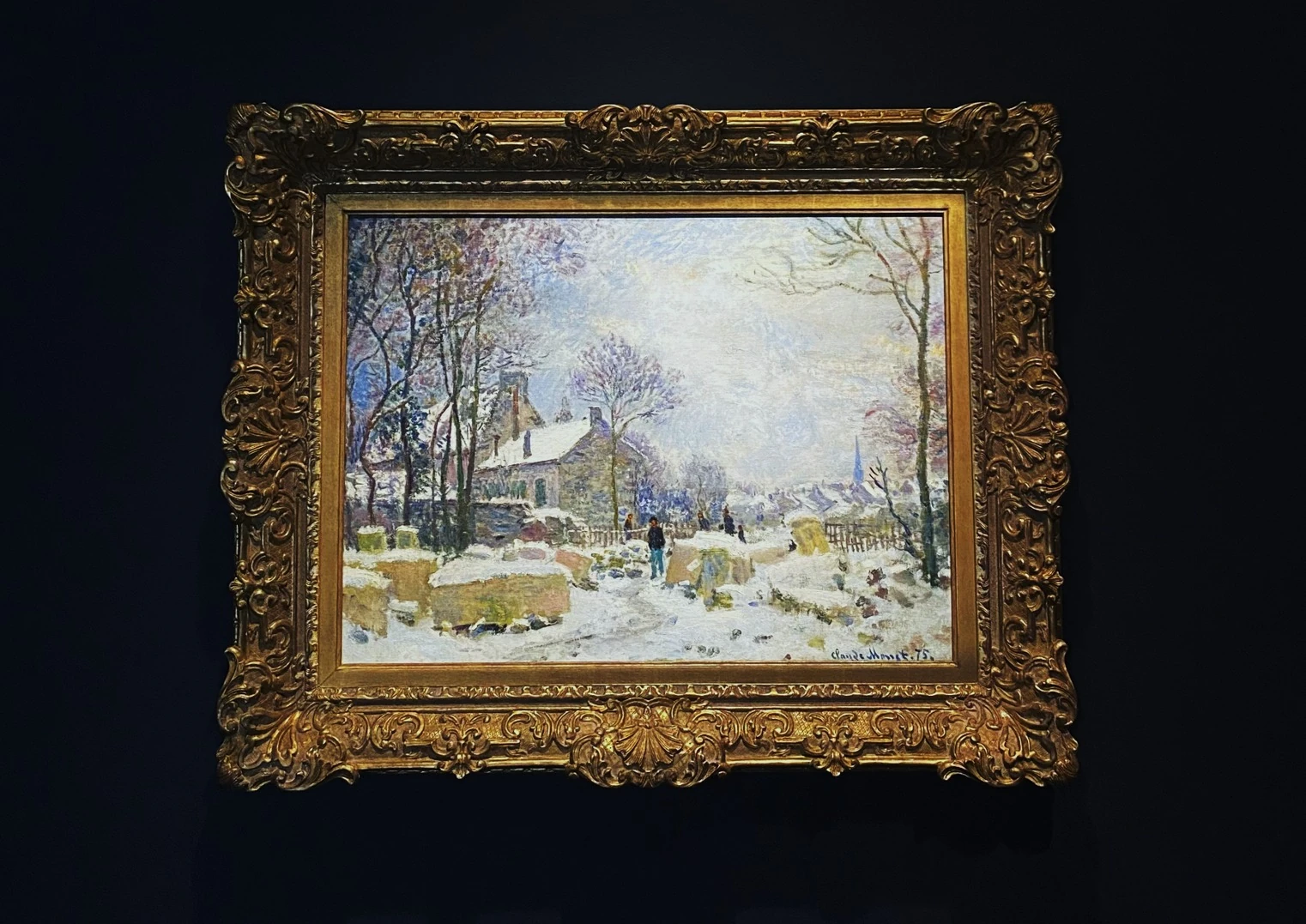 Framed Impressionist winter landscape displayed against a dark wall